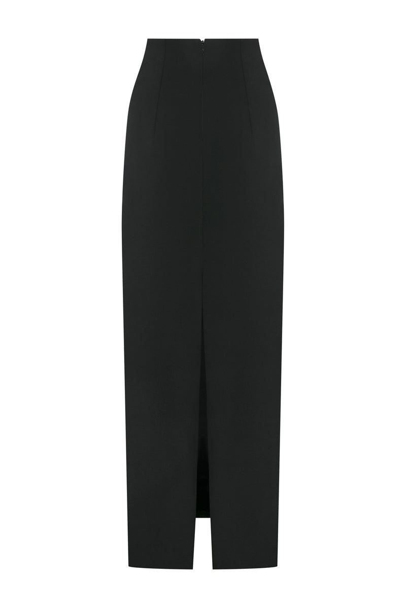 Black TAGG maxi tube skirt with a fitted waist and flowing length, shown on a model against a neutral background.