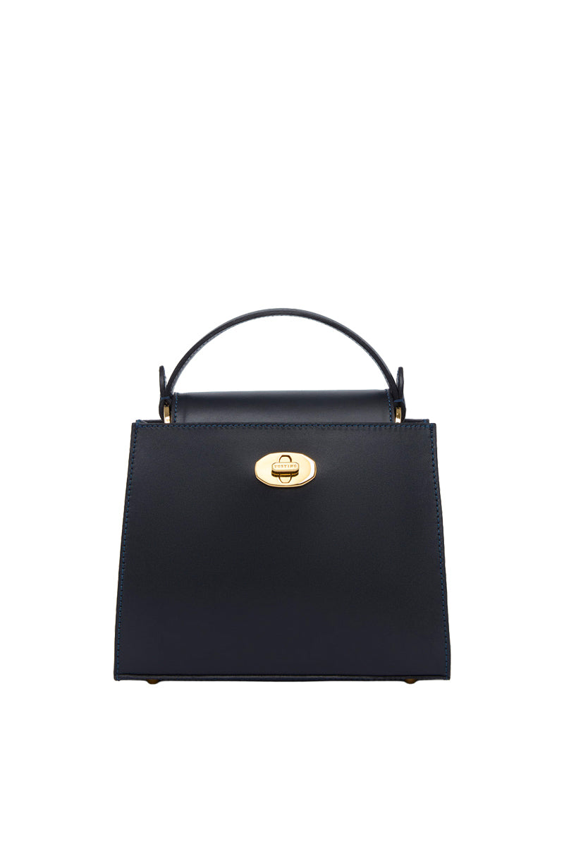TUSTING Clara navy top handle bag with sleek design and structured shape, featuring a sturdy handle and elegant finish.