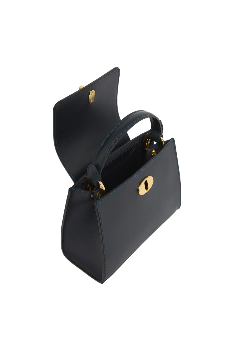 Navy blue CLARA top handle bag by TUSTING, showcasing the elegant design and structured shape with dual top handles.