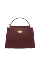 TUSTING Clara Grande oxblood top handle bag with structured design and gold-tone hardware, featuring a sleek, polished appearance.