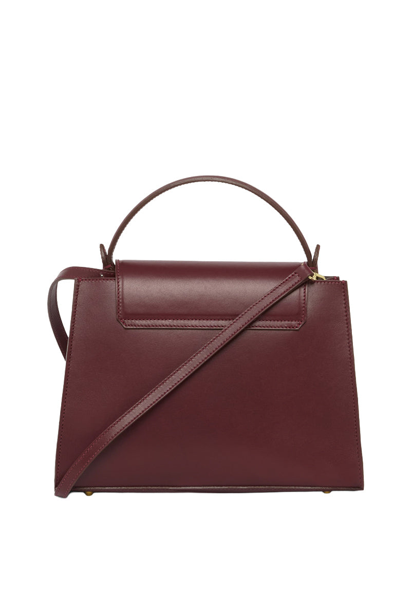 Tusting Clara Grande top handle bag in oxblood leather with sturdy handles and sleek design.