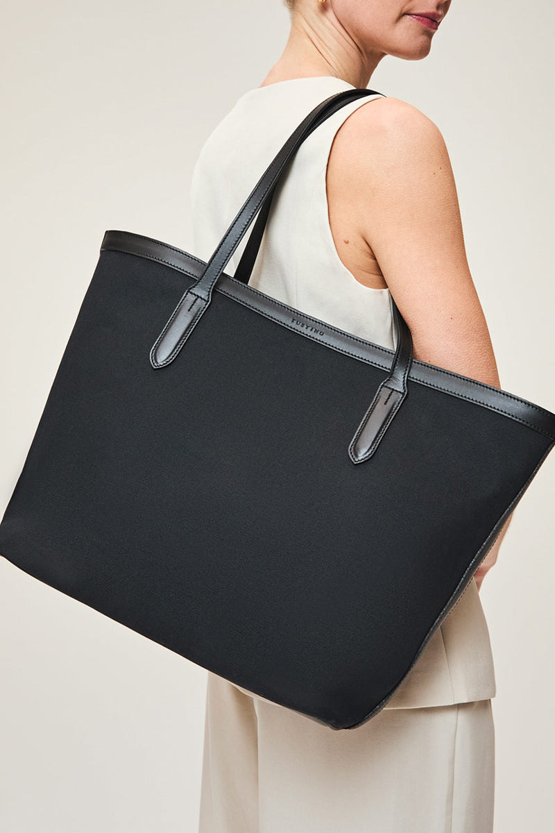 Black TUSTING Canvas Easy Tote shoulder bag with sturdy handles, spacious interior, and minimalist design.