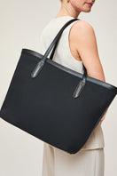Black TUSTING Canvas Easy Tote shoulder bag with sturdy handles, showing a spacious interior and simple, stylish design.
