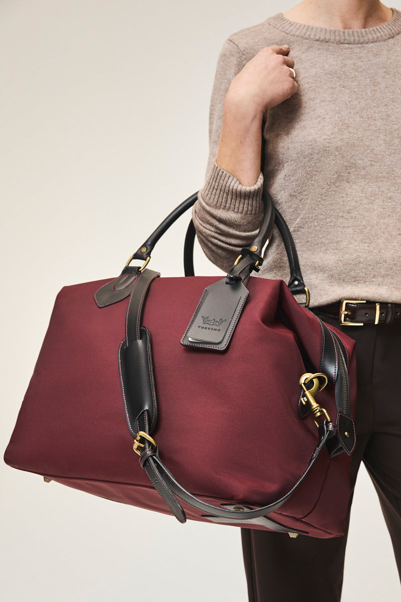 Medium TUSTING Superlight Explorer top handle bag in black with sleek design and sturdy handle, perfect for everyday use.