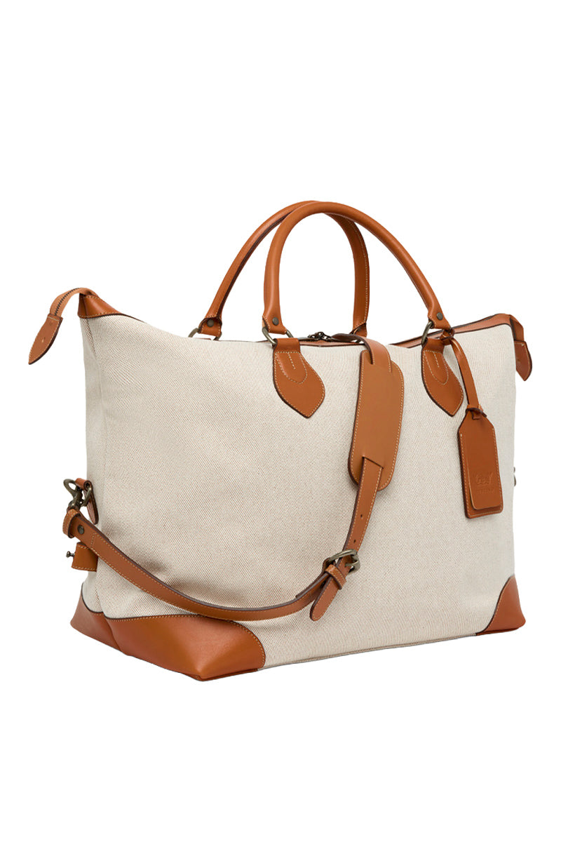 TUSTING COMO Explorer Medium top handle bag in cream with gold accents, featuring a structured design and adjustable strap.