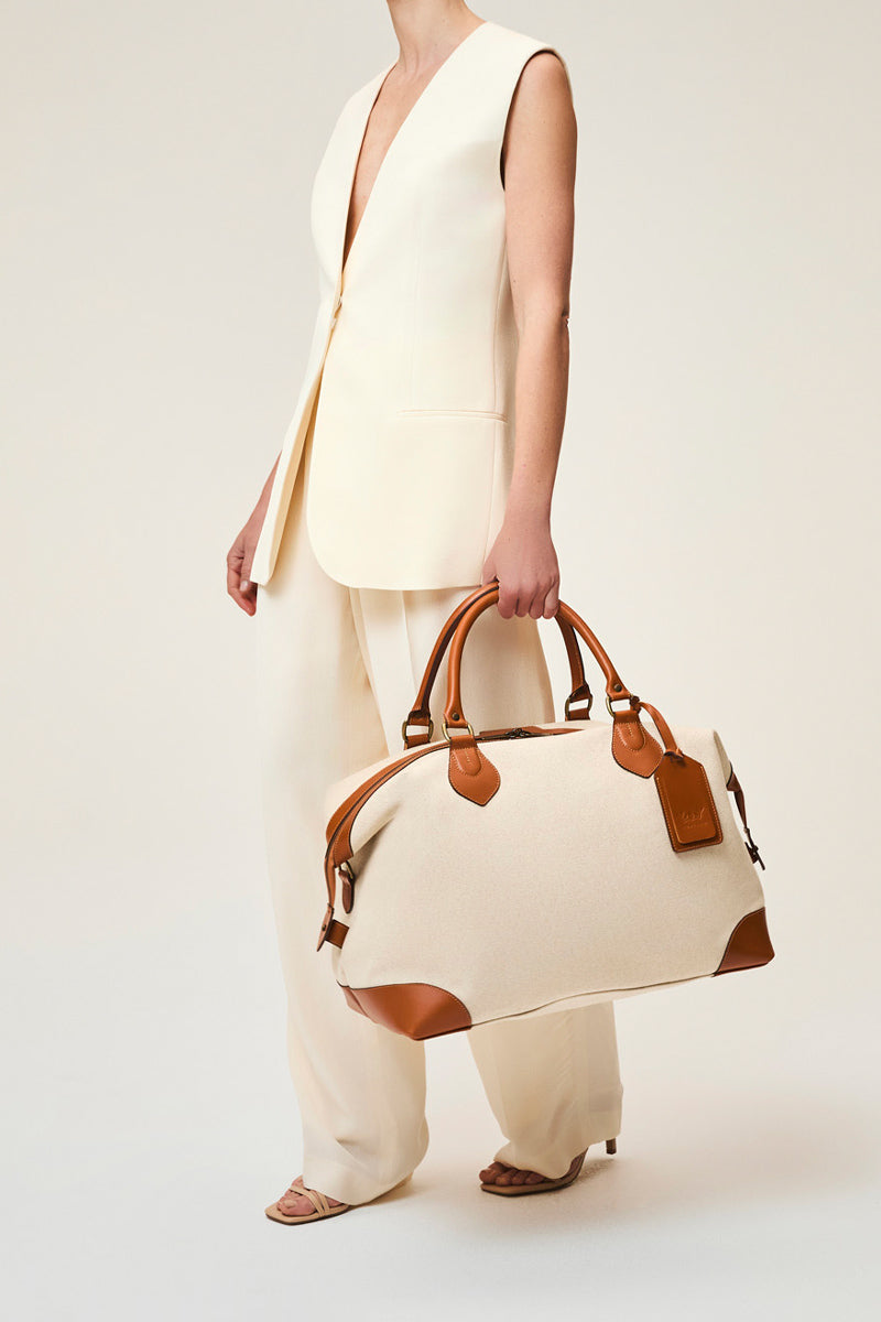 Medium TUSTING COMO EXPLORER top handle bag in black leather with silver hardware and structured design.