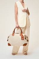 TUSTING COMO Explorer medium top handle bag in cream leather with silver hardware and structured design.