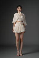 Beige silk cut-out mini dress by 21Six with stylish design and elegant fit, shown on a model.