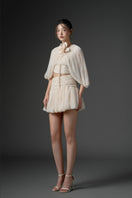 Beige QIRSH silk cut-out mini dress by 21Six, featuring elegant fabric and stylish design, displayed on a mannequin.