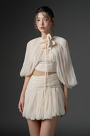 Beige silk cut-out mini dress by 21Six, featuring stylish design and elegant fit, shown on a model.