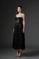Black GHAZAL lace strappy midi dress by 21Six, showcasing a fitted silhouette with intricate lace details and strappy design.