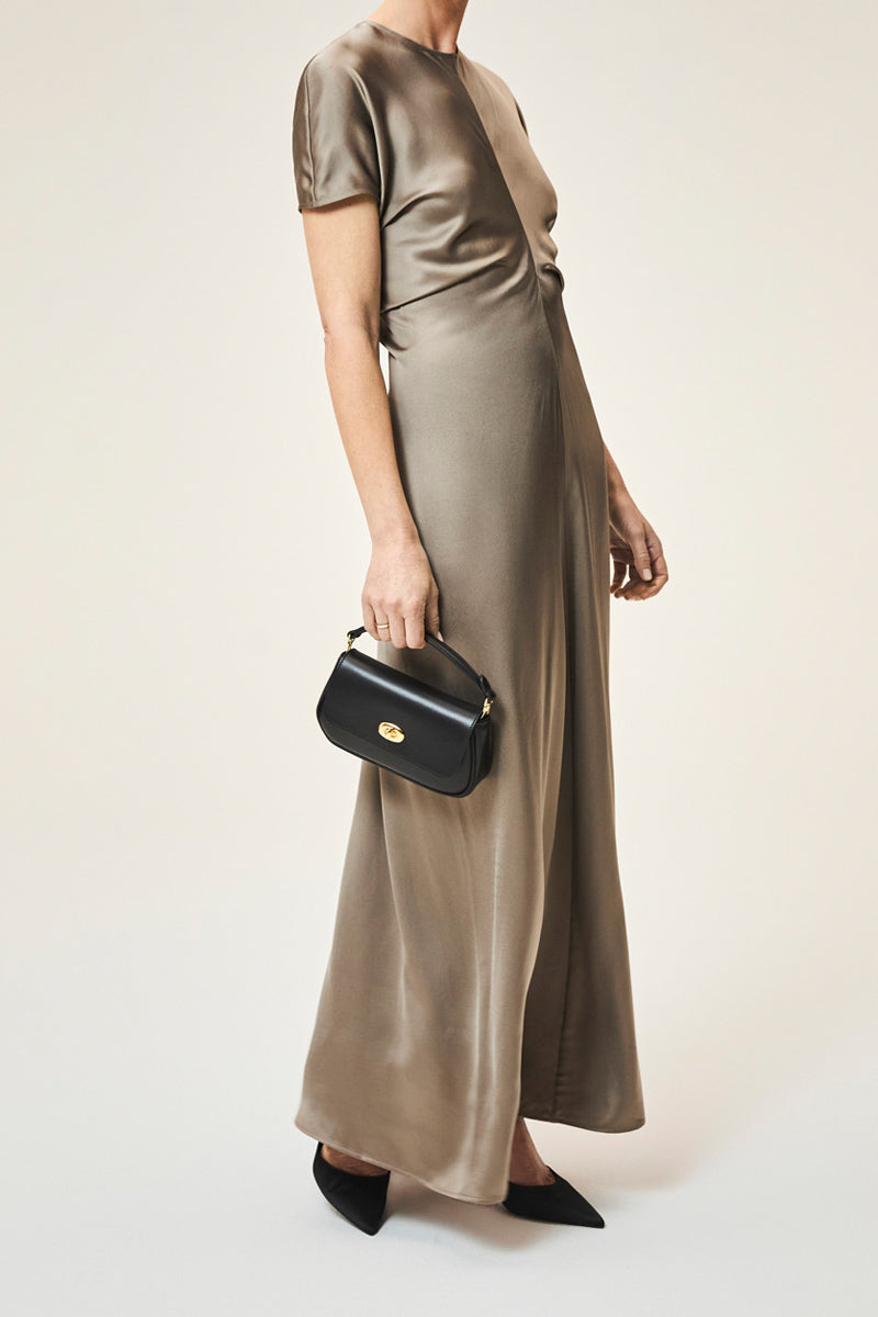 Black TUSTING HETTIE clutch bag with sleek design, featuring a structured shape and subtle detailing, perfect for elegant occasions.