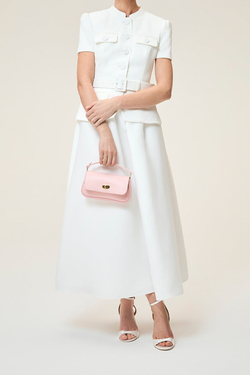 TUSTING Hettie in Blossom clutch bag with floral design, stylish accessory featuring a compact, elegant look.