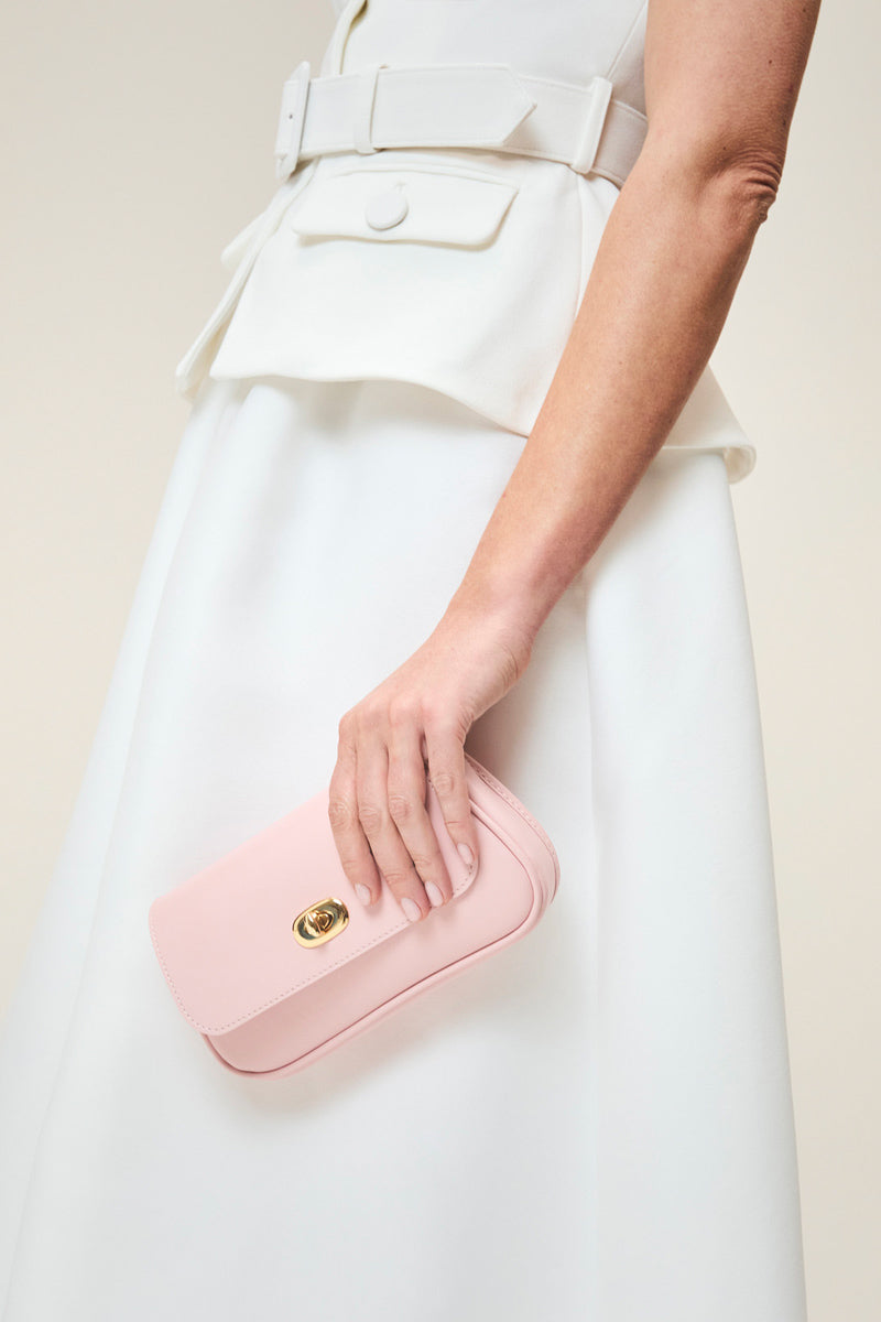TUSTING Hettie in Blossom clutch bag with floral design and zipper closure, stylish accessory for special occasions.