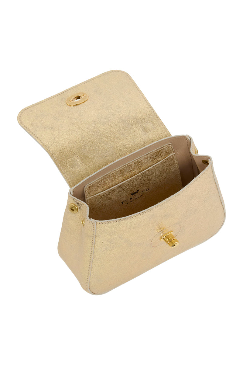 Mini Holly in gold suede Tusting top handle bag with sleek design and gold hardware, shown in a close-up view.
