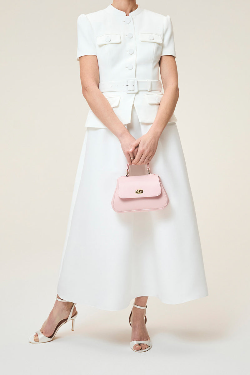 Mini Holly in Blossom top handle bag by TUSTING, featuring a floral design and compact size with a top handle and elegant details.
