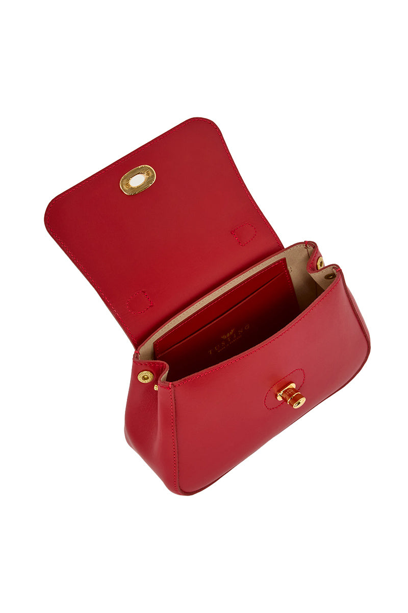 Mini Holly in Crimson top handle bag by TUSTING, featuring a compact design with a stylish crimson leather exterior and gold-tone hardware.