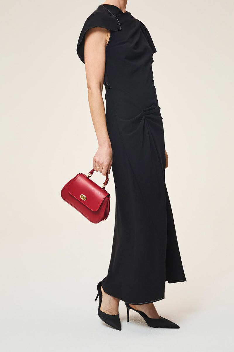TUSTING Mini Holly crimson top handle bag with gold-tone hardware and structured design, featuring a sleek, compact silhouette.