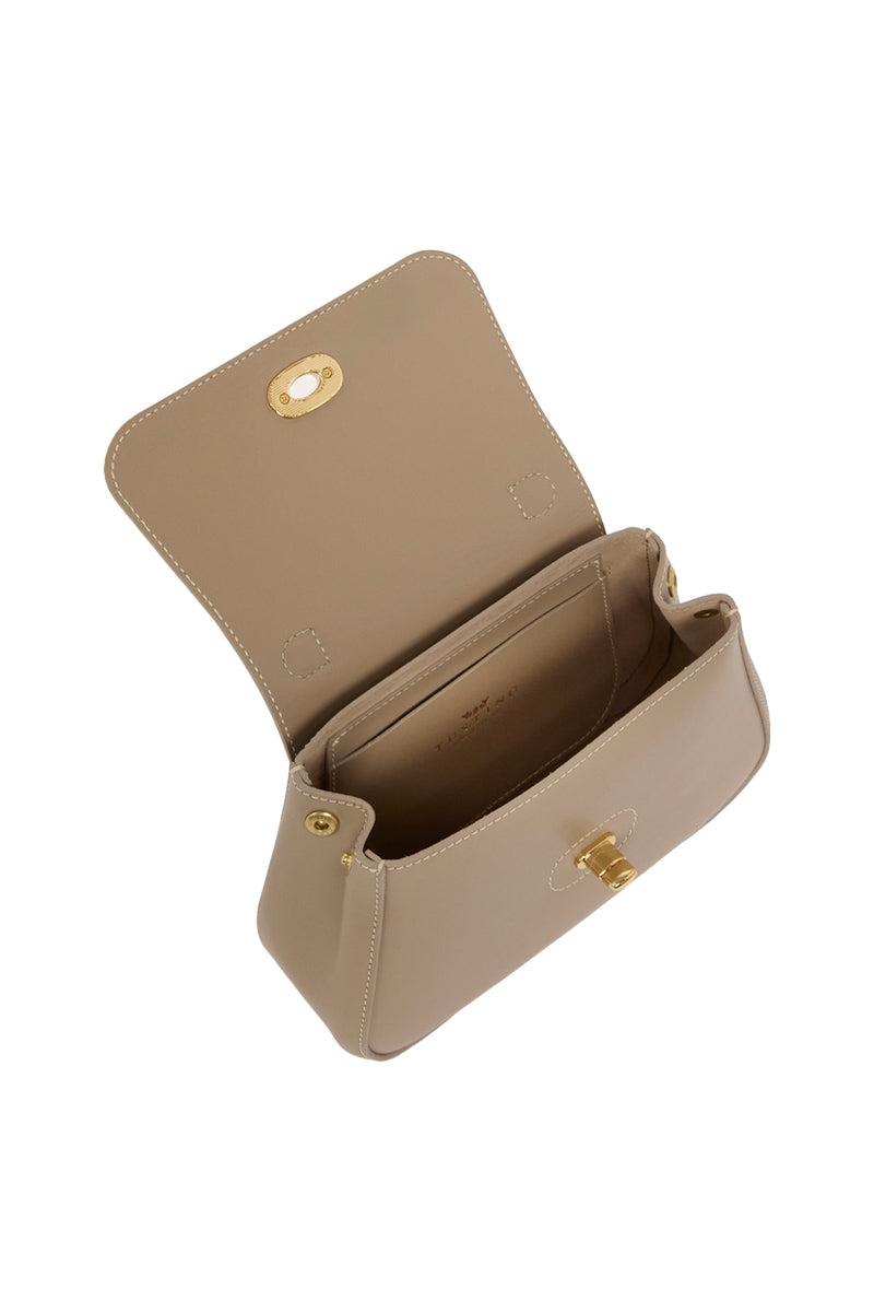 Mini Holly taupe top handle bag by TUSTING, showing a sleek compact bag with a top handle and subtle texture.