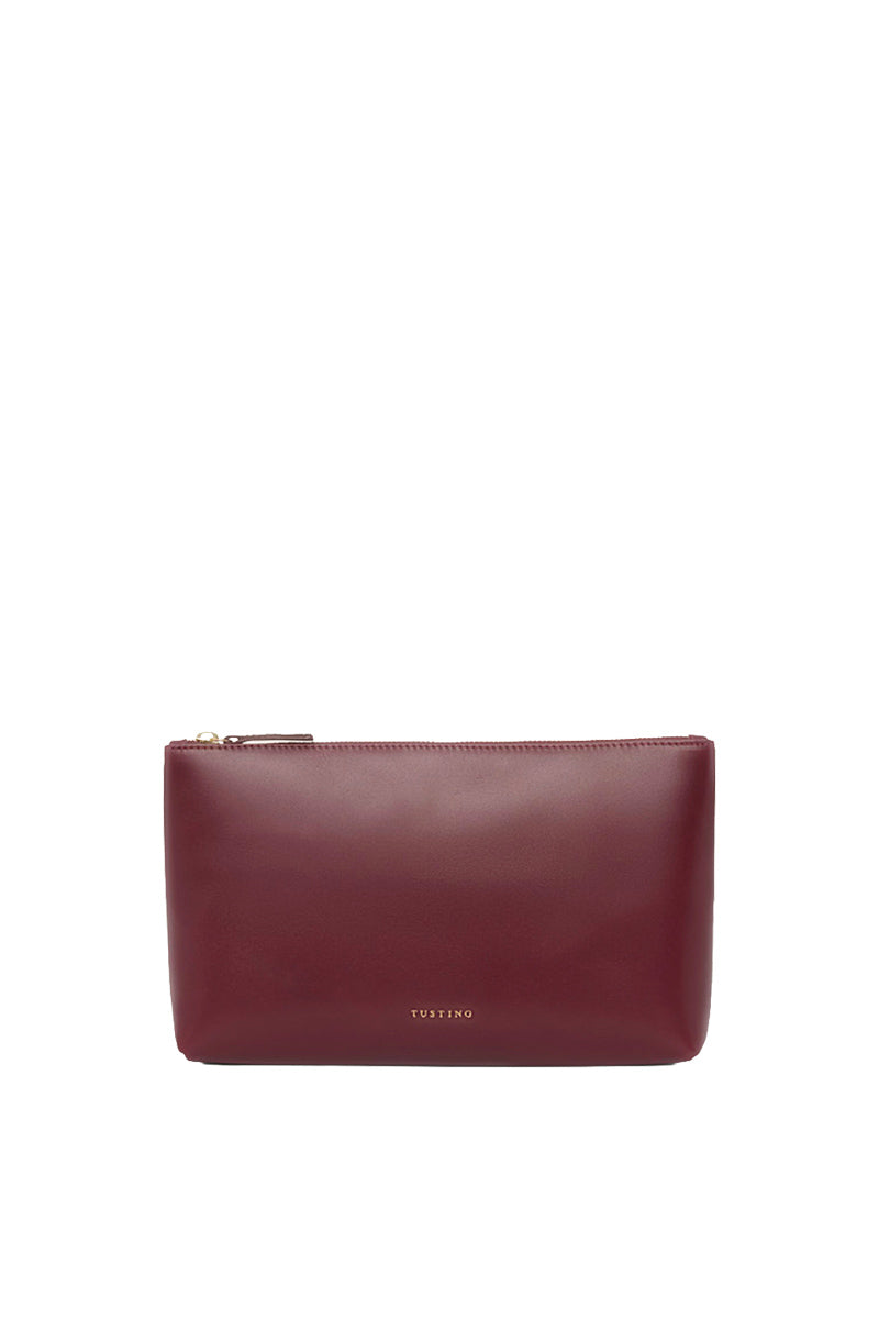 TUSTING oxblood leather pouch with top handle, showcasing a sleek, compact design perfect for everyday use.