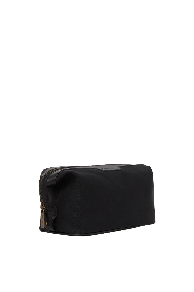 TUSTING Horizon canvas and leather top handle bag in Como canvas with black trim, featuring a sleek design and sturdy handle.
