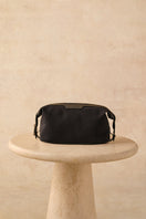 TUSTING Horizon canvas and leather clutch in Como canvas with black trim, featuring a sleek design and compact size.