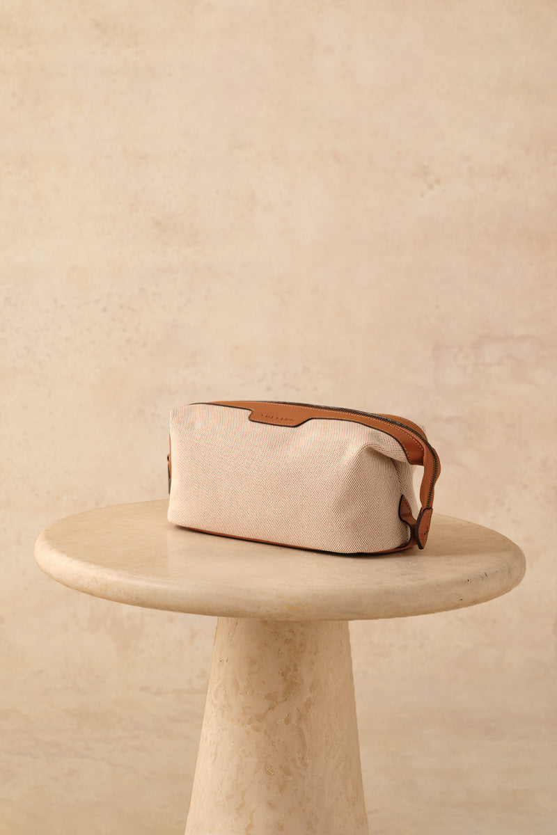TUSTING Horizon canvas and leather top handle bag in Como canvas with tan trim, showcasing its stylish design and craftsmanship.