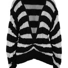 Two-tone knitted sweater in ivory and black by MAZ Manuela Álvarez, showing the front view with a cozy, stylish design.