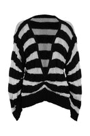 Two-tone knitted sweater in ivory and black by MAZ Manuela Álvarez, showing the front view with a cozy, stylish design.