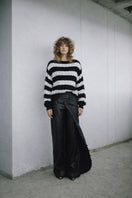Ivory and black two-tone knitted sweater by MAZ Manuela Álvarez, featuring a cozy, stylish design and textured knit pattern.