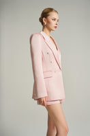 Light pink double-breasted blazer from I.H.F Studio featuring classic lapels and tailored fit on a hanger.