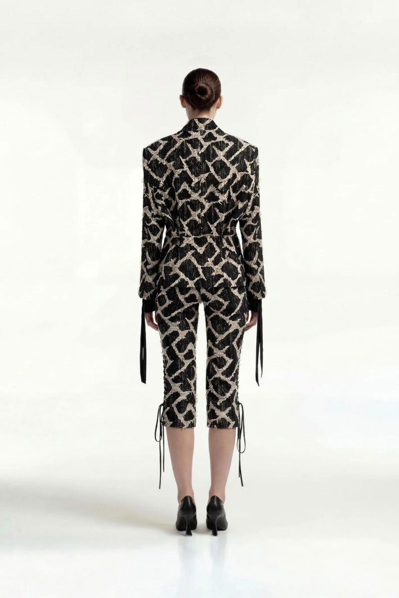 Black and gold button tailored jacket by Tayfun Kaba, featuring a sleek design and elegant details.