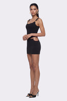 Black Tallulah mini skirt by Nana Jacqueline featuring a ring cutout design, shown on a model in a lookbook setting.