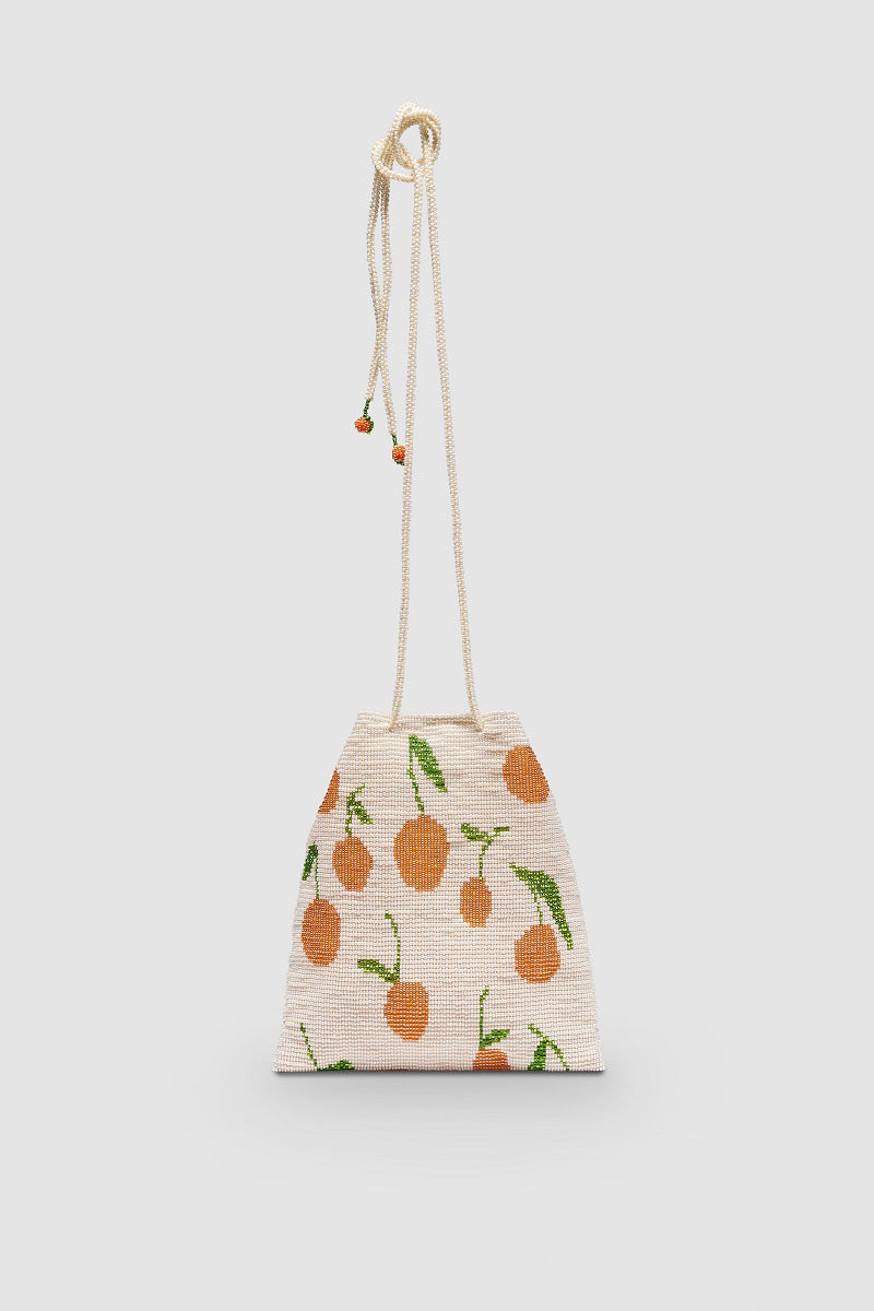 Beige Pura Utz shoulder bag featuring a tangerine-colored pouch with a sleek design and adjustable strap.