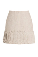 ANA + MARIA Tatti Sand mini skirt displayed on a model, showcasing its casual fit and neutral sandy color.
