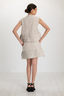 Ana + Maria Tatti skirt in sand, stylish mini skirt with a flattering fit, shown in a natural pose on a plain background.