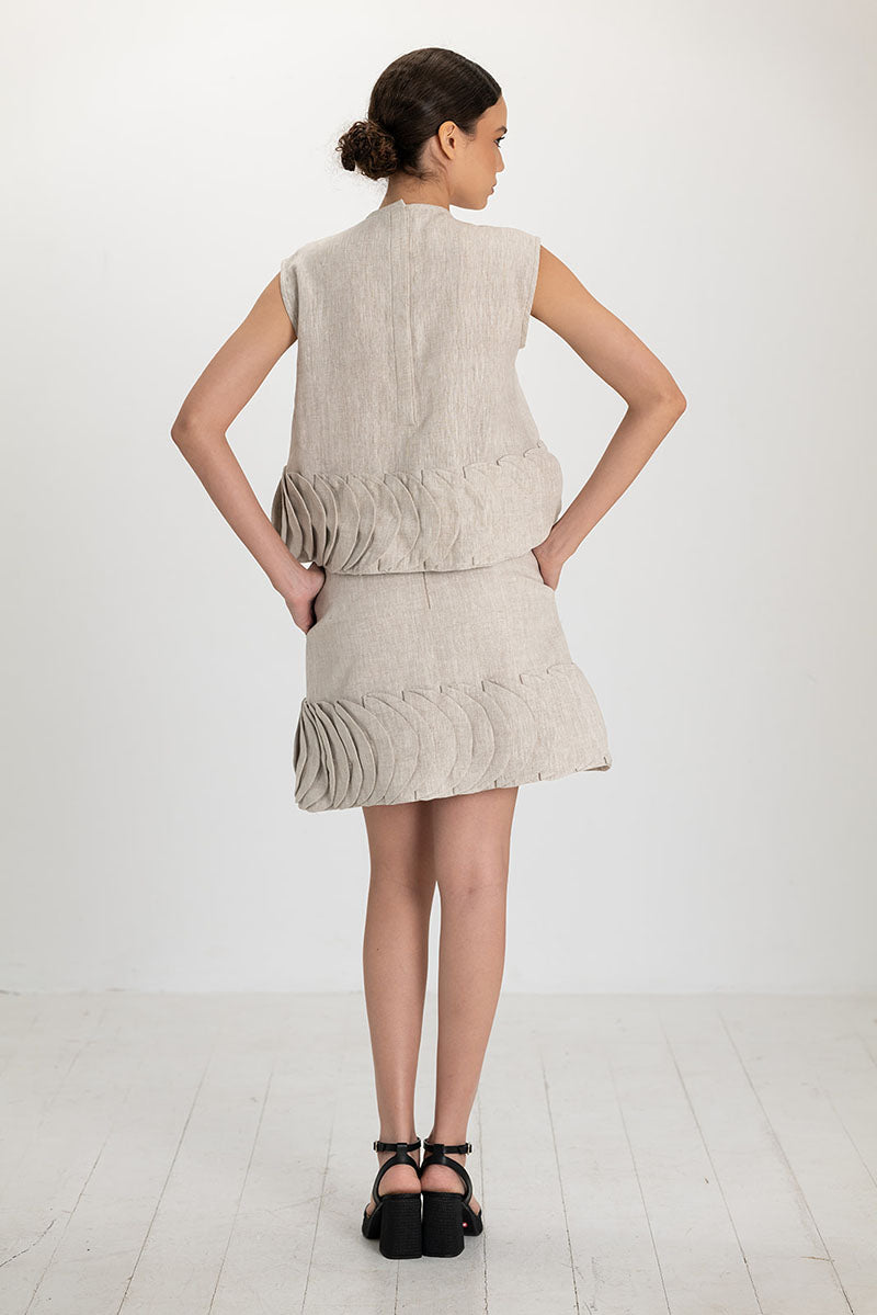 Ana + Maria Tatti skirt in sand, stylish mini skirt with a flattering fit, shown in a natural pose on a plain background.