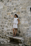 Ana + Maria Tatti top in sand, stylish sleeveless blouse with a relaxed fit, shown in a fashion campaign photo.