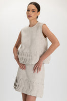 ANA + MARIA TATTI top in sand color, featuring a stylish sleeveless design, shown on a model with a casual, chic look.