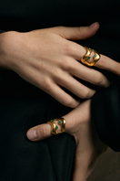 Gold TENA EMERALD RING by Fenomena featuring a vibrant emerald gemstone and intricate band design.