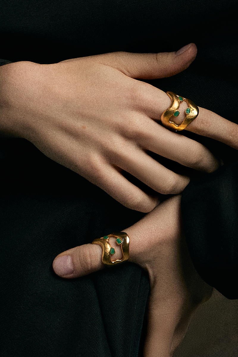 Gold TENA EMERALD RING by Fenomena featuring a vibrant emerald gemstone and intricate band design.