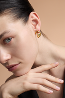 Gold TENA Emerald Studs earrings by Fenomena featuring vibrant emerald green gemstones and a sleek, elegant design.