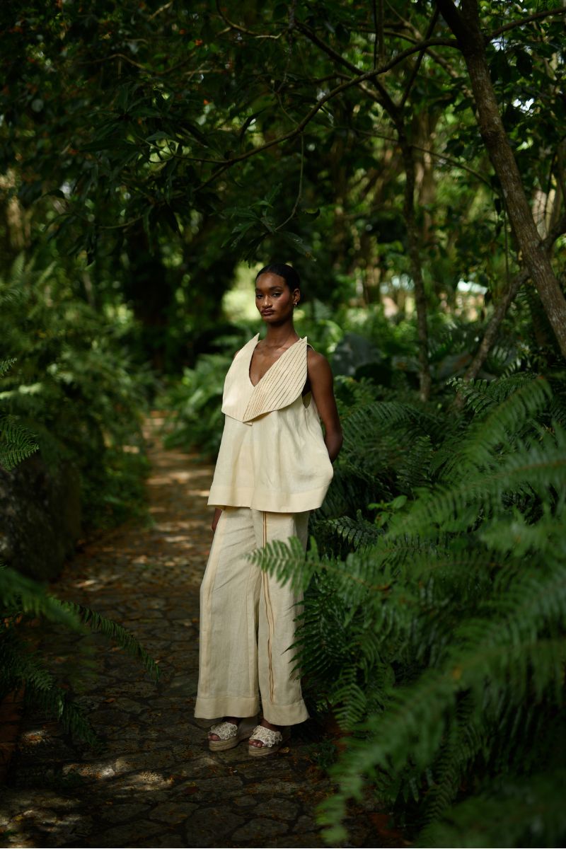 Yellow Terra Pants by ANA + MARIA shown in a campaign image, featuring a relaxed fit and vibrant butter yellow color.