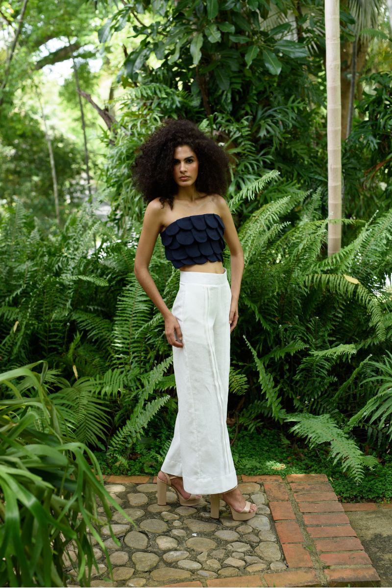 ANA + MARIA Terra pants in ivory, stylish and comfortable pants with a relaxed fit, shown in a natural campaign setting.