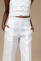 Ivory Terra Pants by Ana + Maria displayed on a model, showcasing a stylish, comfortable pair of pants with a relaxed fit.