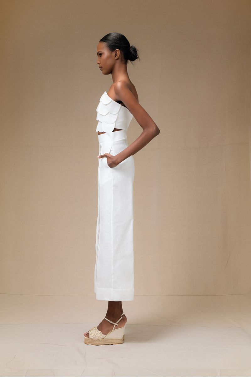 Cream-colored Terra Pants by Ana + Maria displayed in a stylish campaign photo, showcasing the relaxed fit and soft fabric.