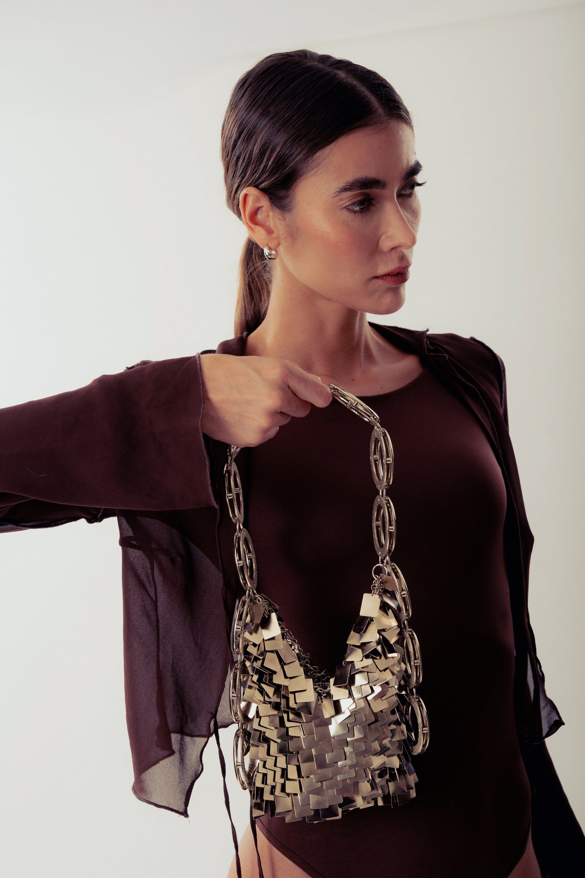 Silver Thais shoulder bag by Millanne Tale featuring a sleek metal design and adjustable strap for everyday style.