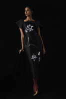 Black Tiny Ink The Twist Orchid Midi Dress with a fitted waist and elegant drape, shown on a mannequin.