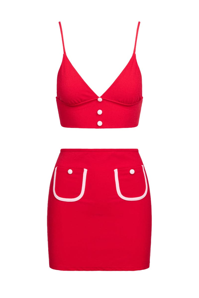 Talia Collins red terry bralette and pocket skirt co-ords set displayed on a model in a casual indoor setting.
