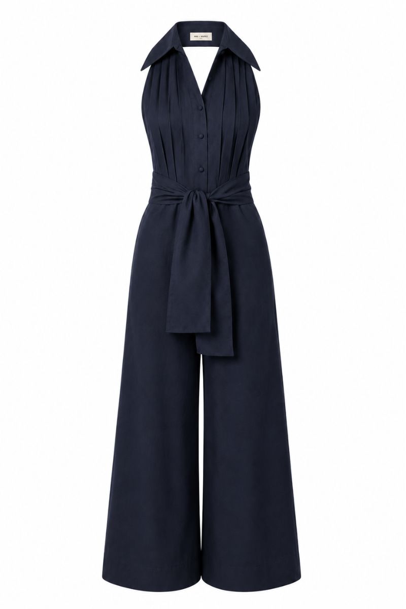 Navy blue ANA + MARIA wrapped jumpsuit on ghost mannequin, featuring a fitted waist and wide-leg design.